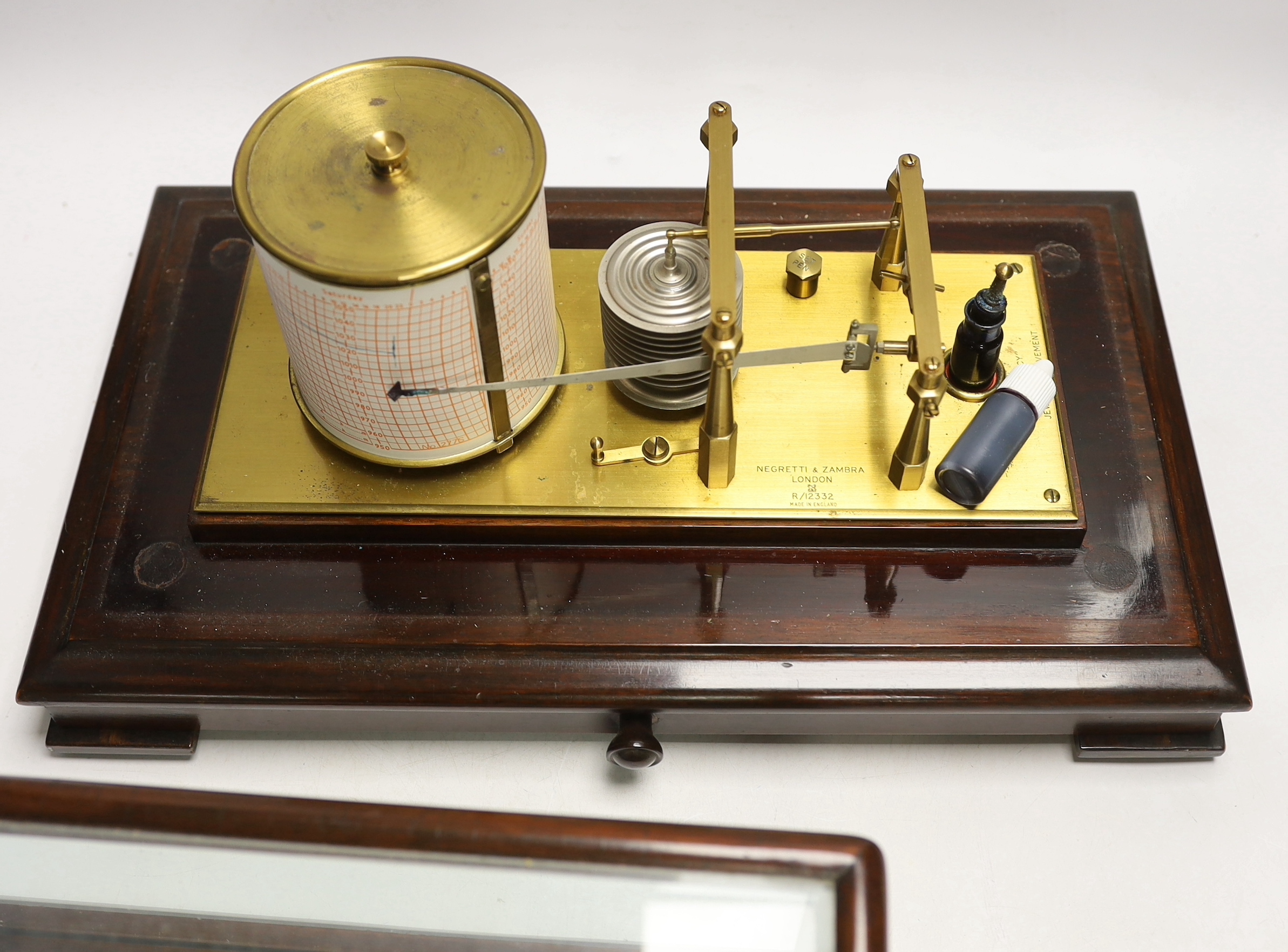 An early 20th century Negretti & Zambra barograph, engraved ‘made in England’, in a mahogany case, with drawer below, 42cm wide